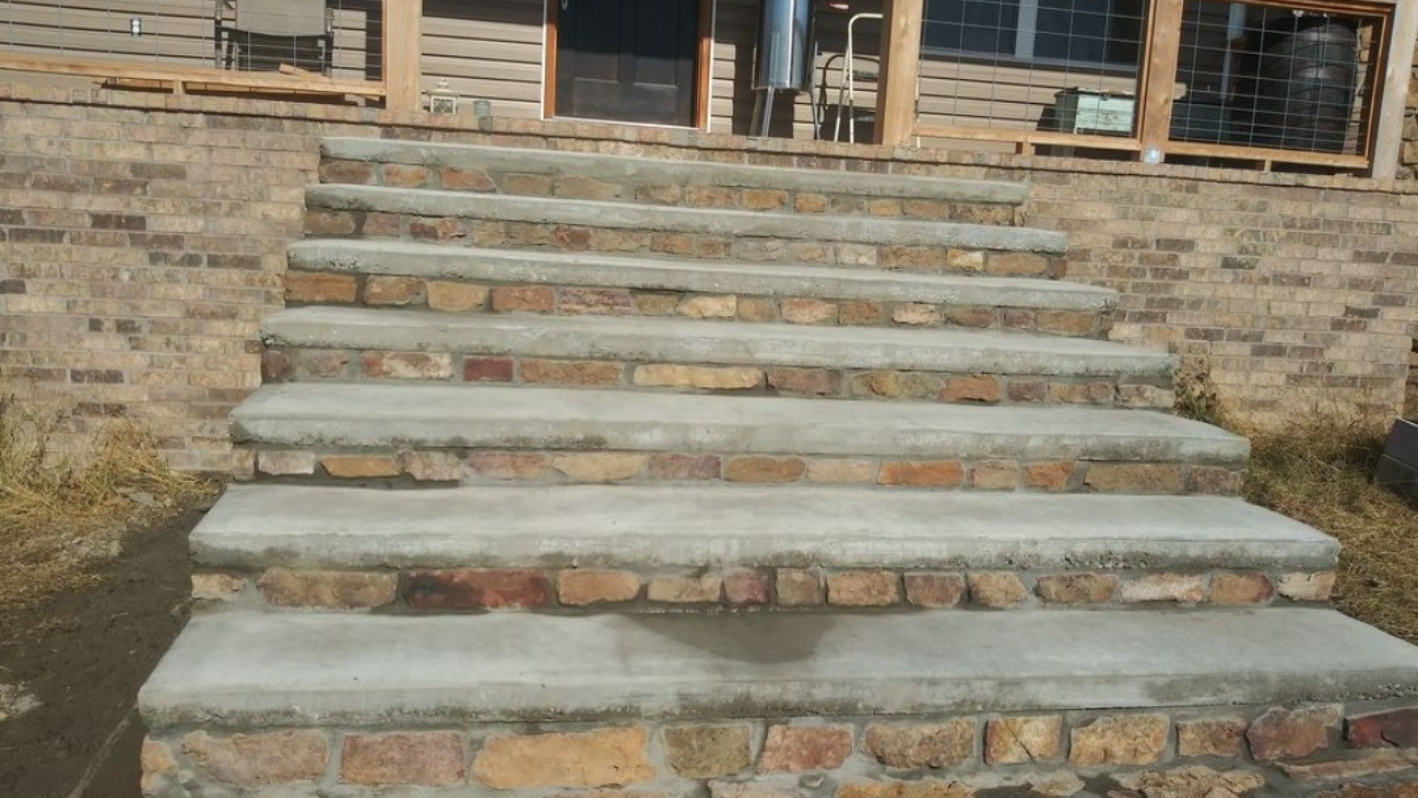 A set of stone steps leading up to a brick building